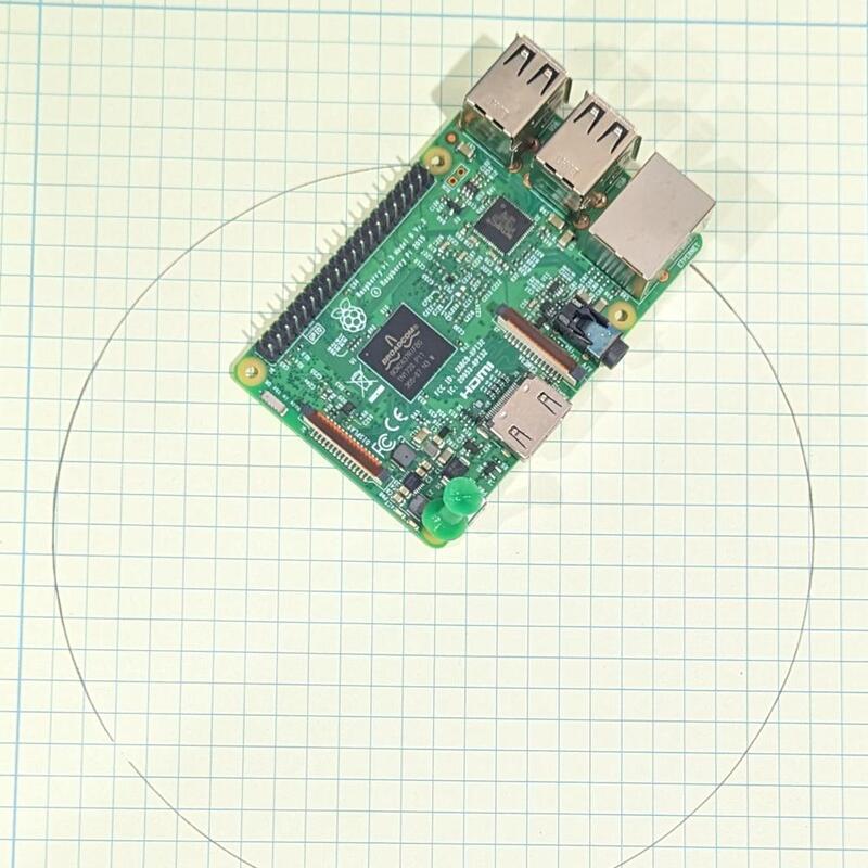 a circle on graph paper, drawn using a Raspberry Pi computer board as a compass