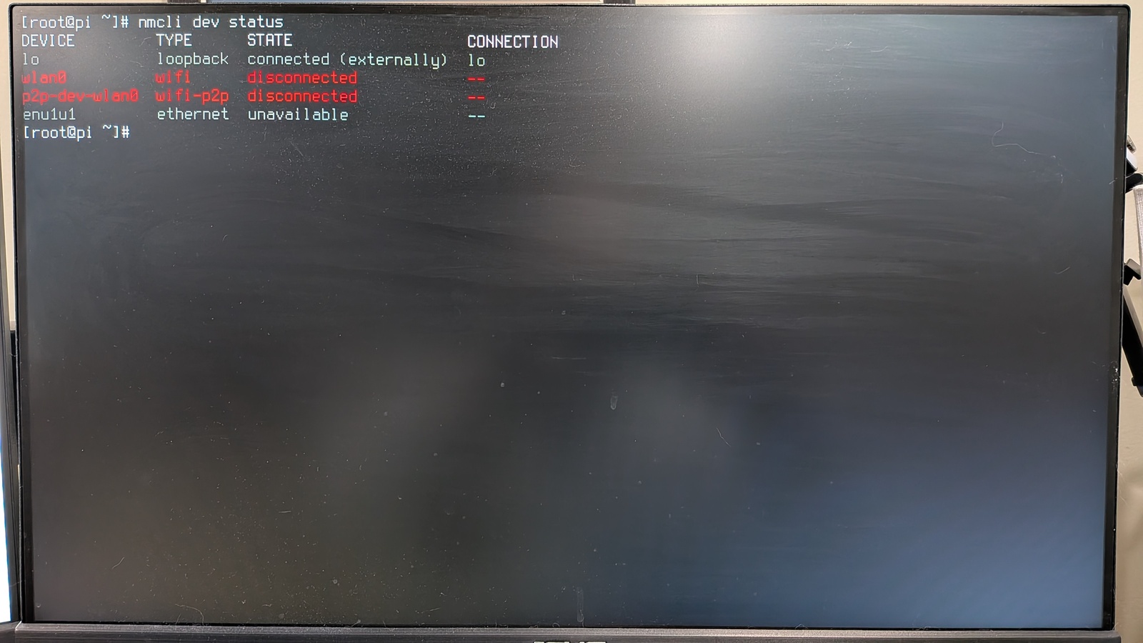 Command line output for 'nmcli dev status' with the wireless network shown as disconnected.
