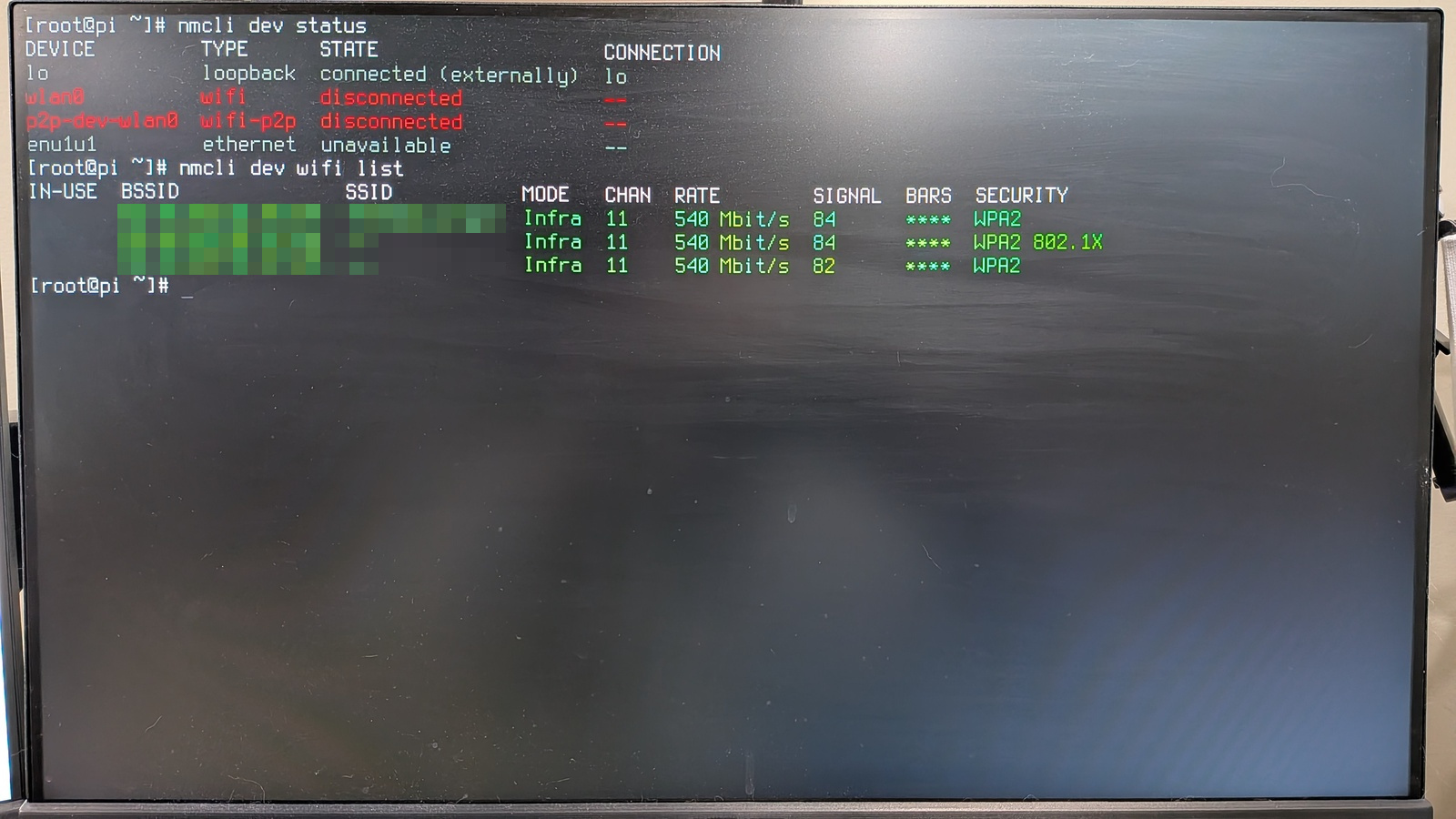 Command line output for 'nmcli dev wifi list' with the available wireless networks shown in green.