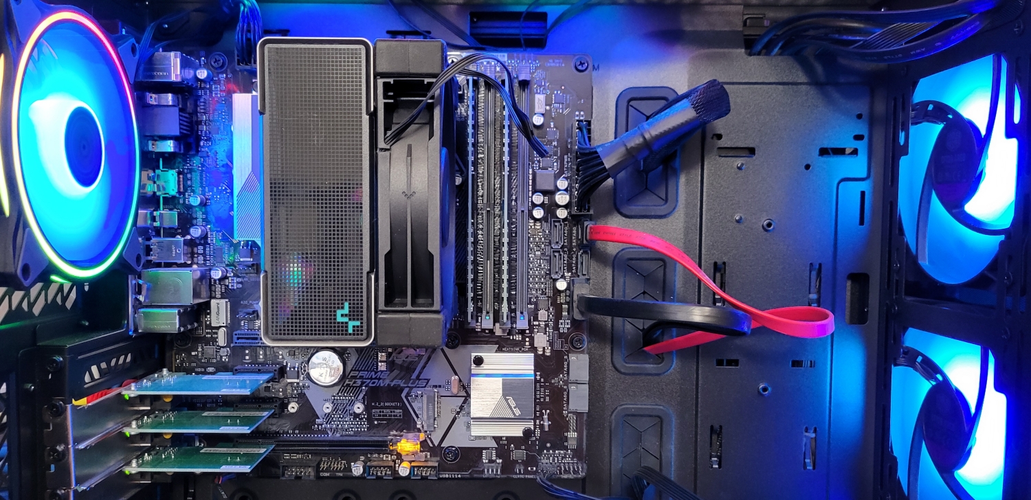 Closeup of the inside of a computer with the motherboard and a large CPU air-cooling system.