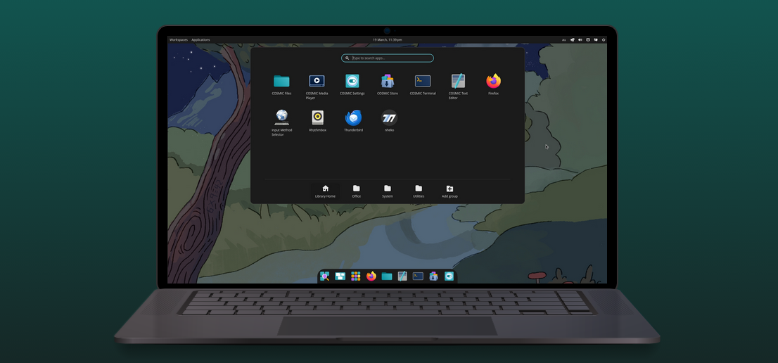 Image of a Laptop with the Fedora Cosmic Atomic desktop on the screen.